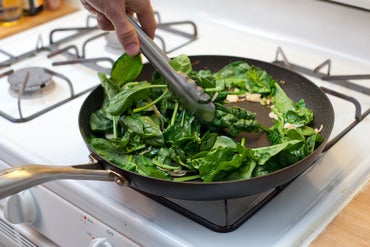 Cook the spring onion & wilt the spinach: