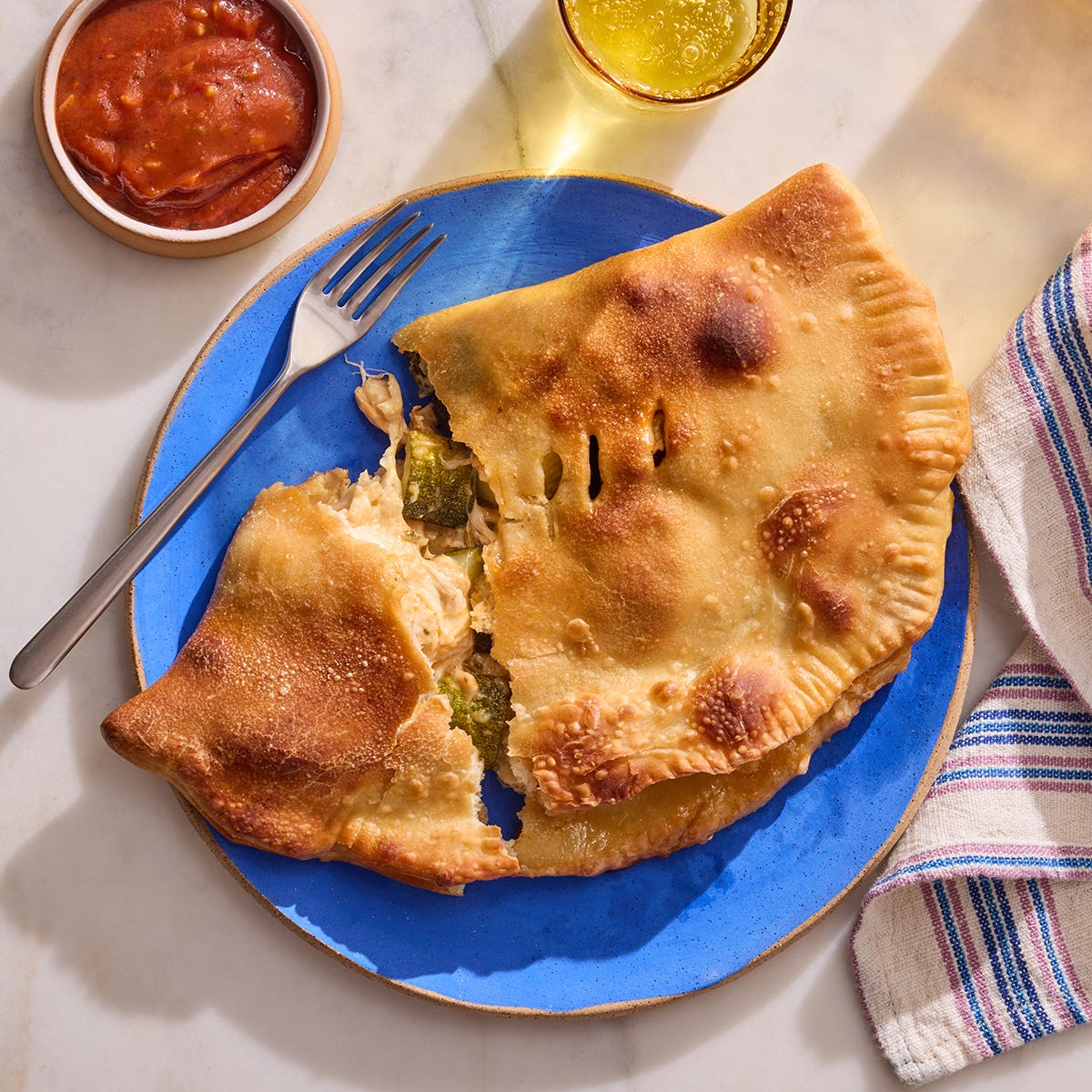 Recipe Three Cheese Calzones with Zucchini & Golden Raisins Blue Apron
