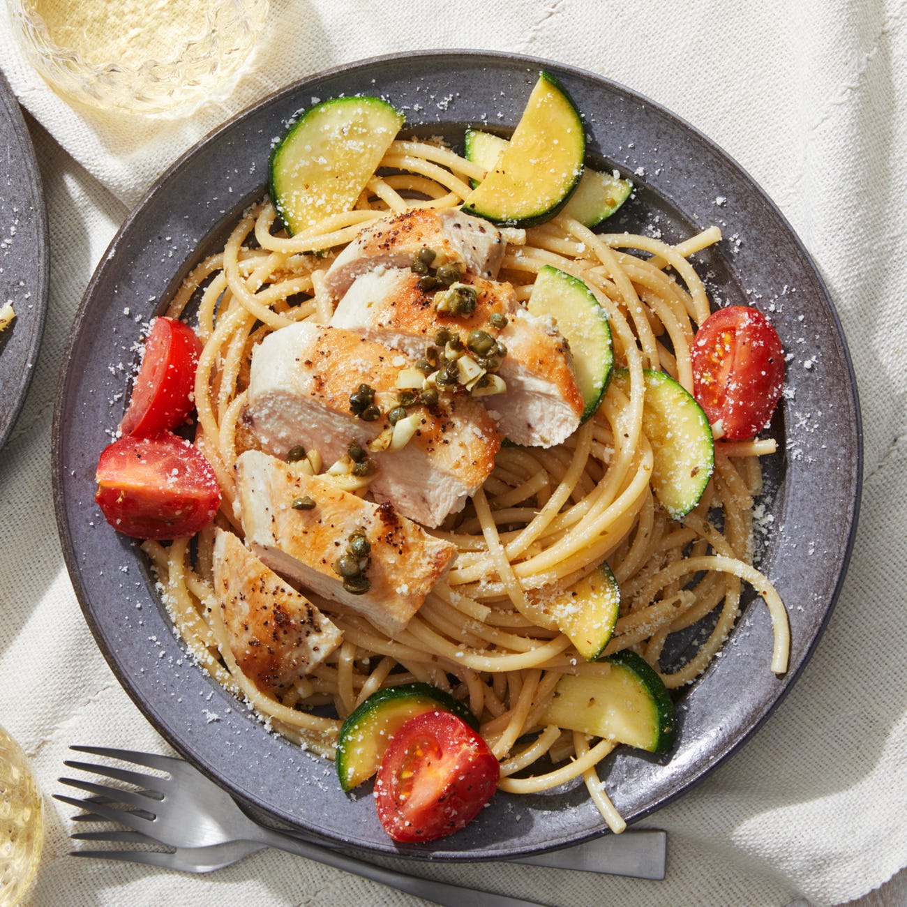 Recipe GarlicCaper Chicken over Bucatini with Summer Vegetables